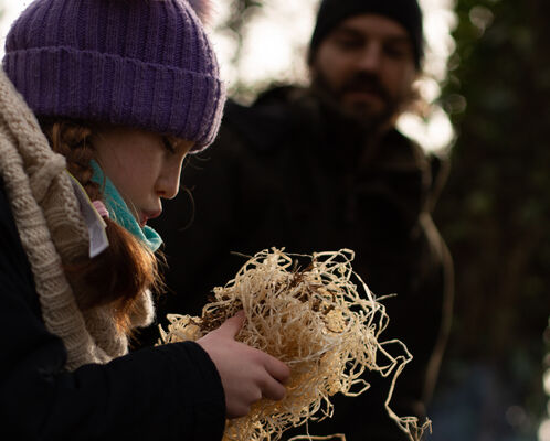 Young girl making a fire